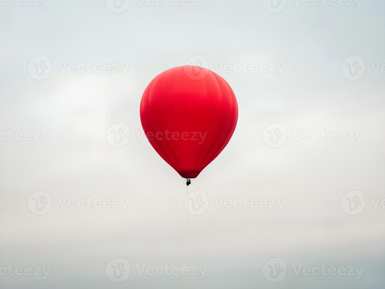 Red Hot Air Balloon Ascending in a Cloudy Sky photo
