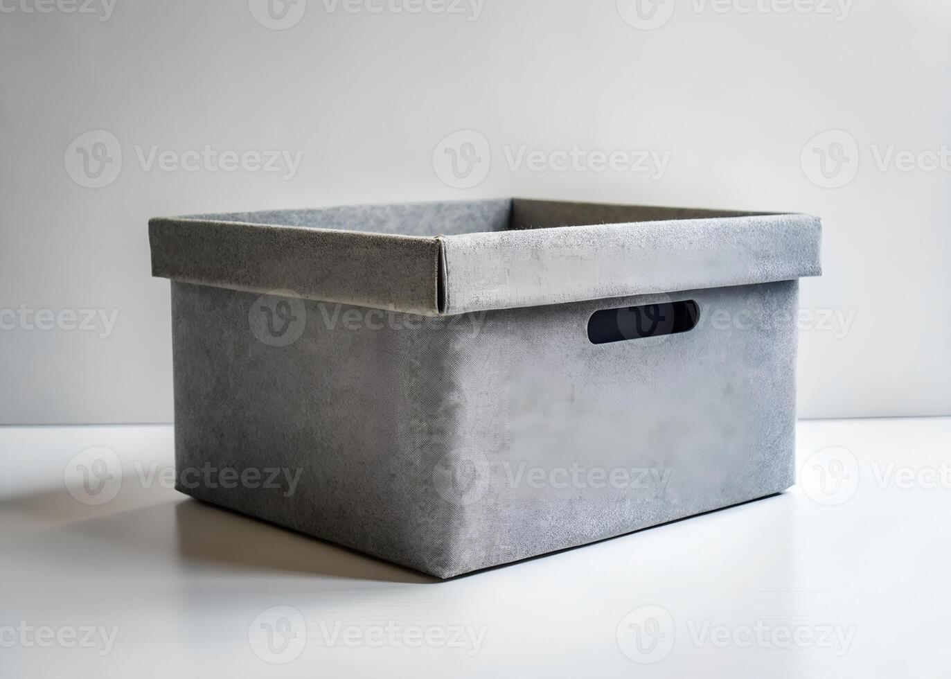 a gray box with a lid on a white surface photo