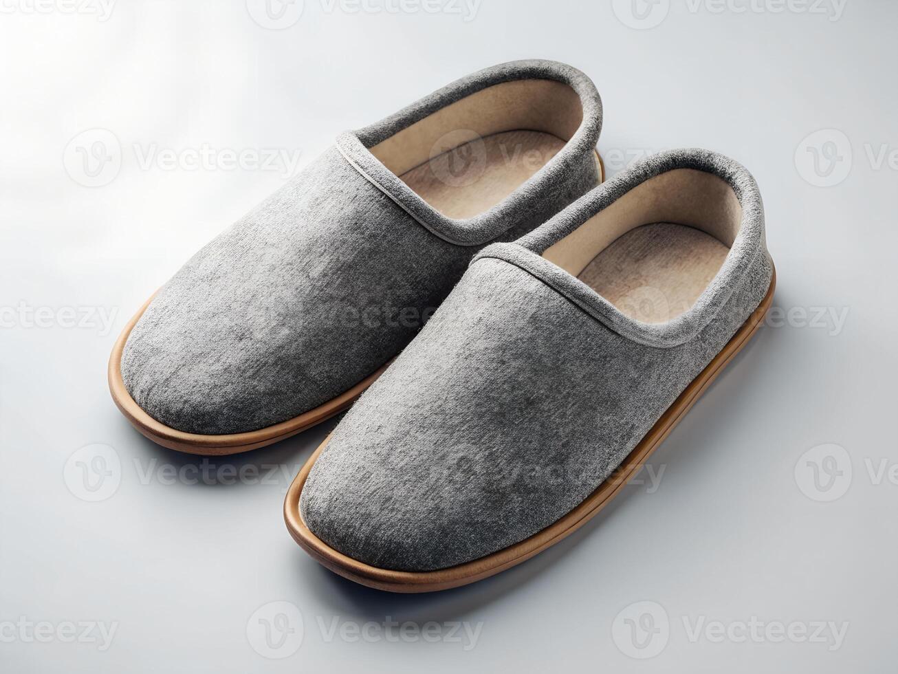 Pair of Gray Wool Slippers with Beige Soles on White Background photo