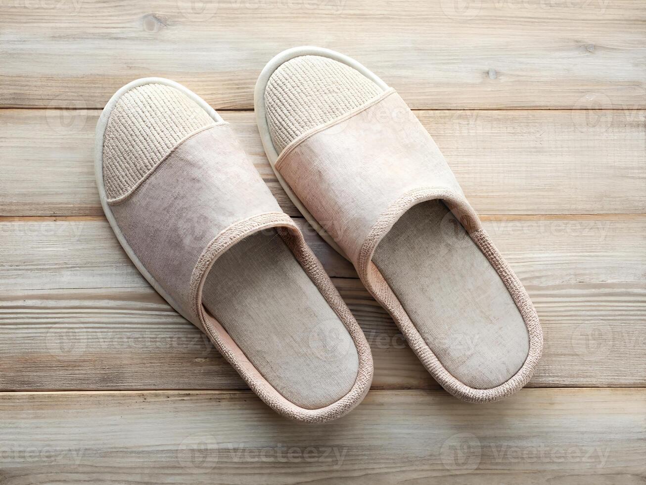 Beige Knitted Slippers on Light Brown Wooden Floor photo