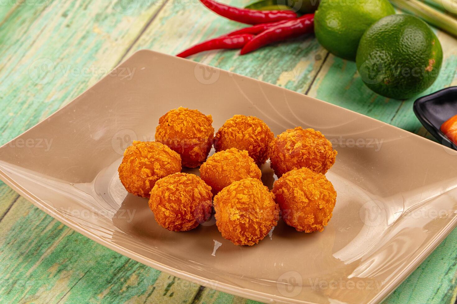 A plate of fried balls of food on a table photo