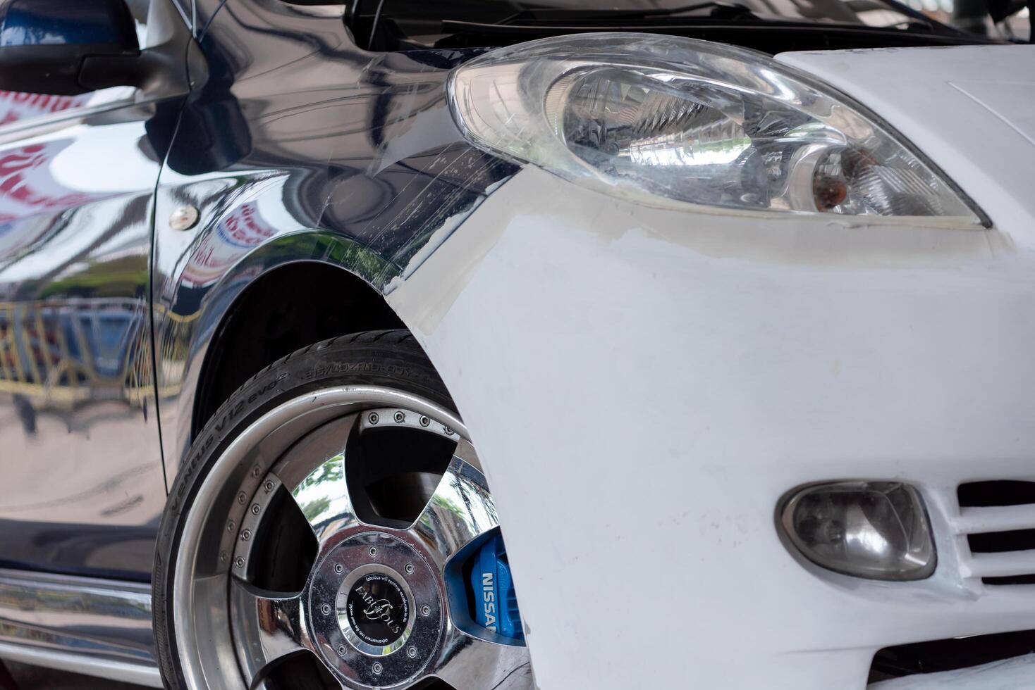 A white car with a blue stripe on the front photo