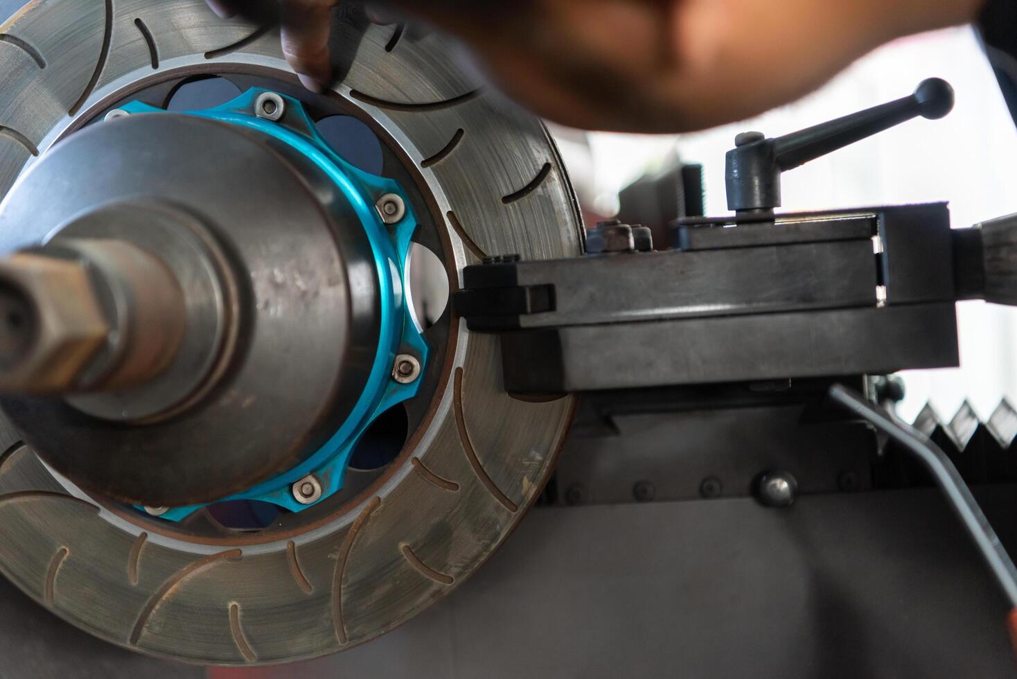 A man is working on a brake disc photo