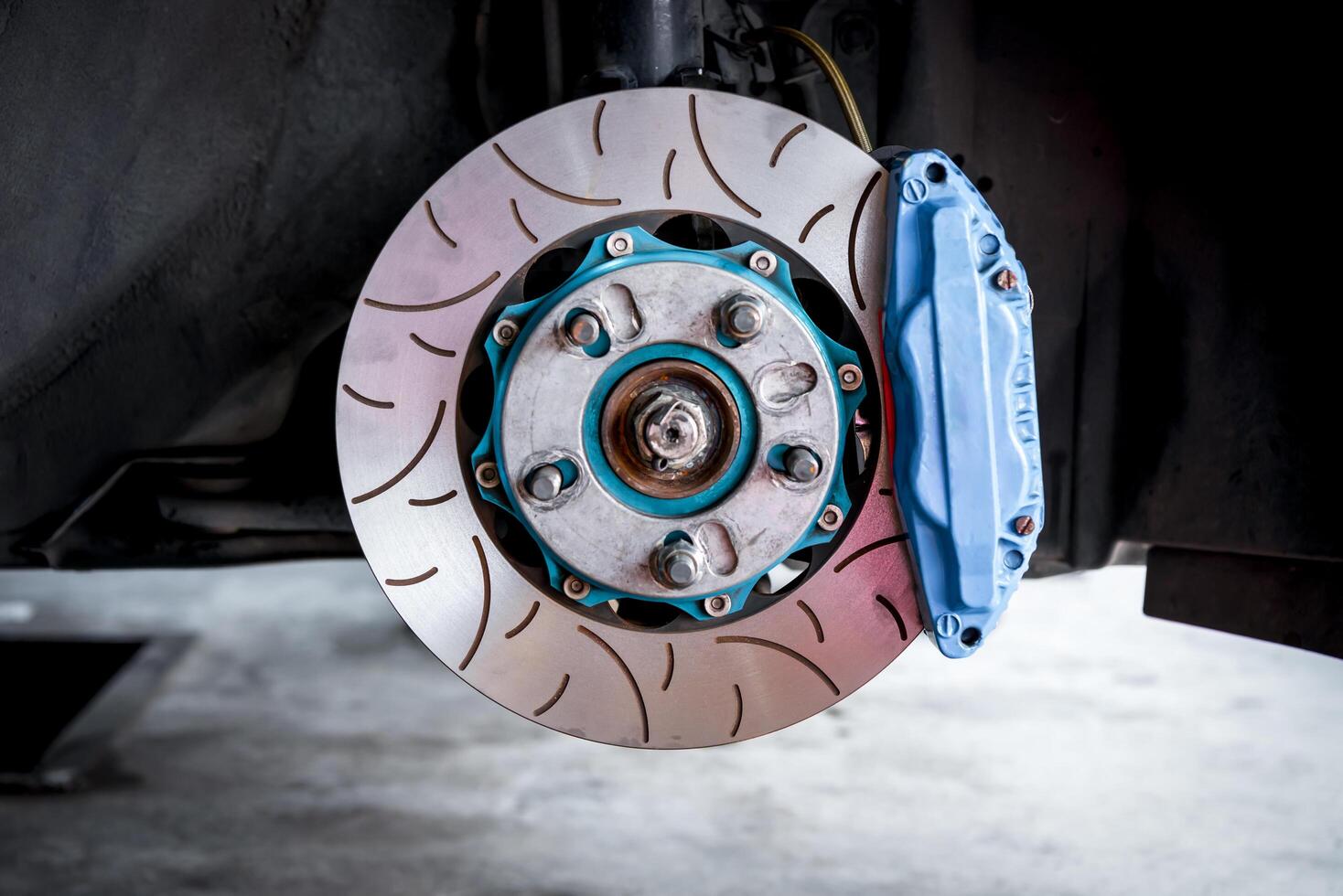 A close up of a brake disc and brake pads photo