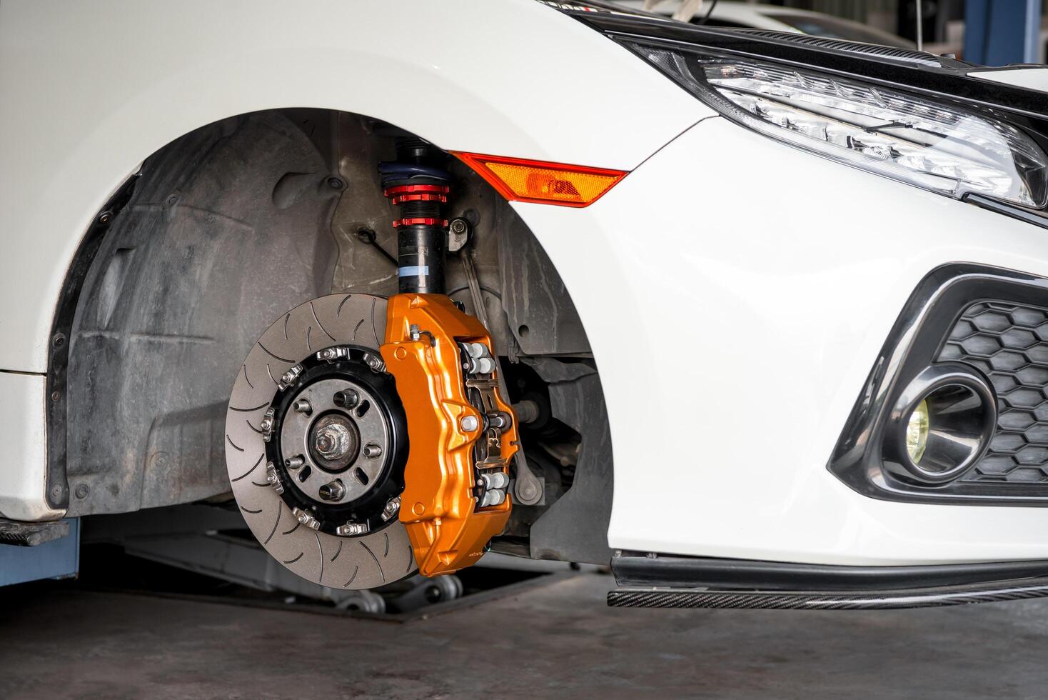 A close up of a brake disc on a white car photo