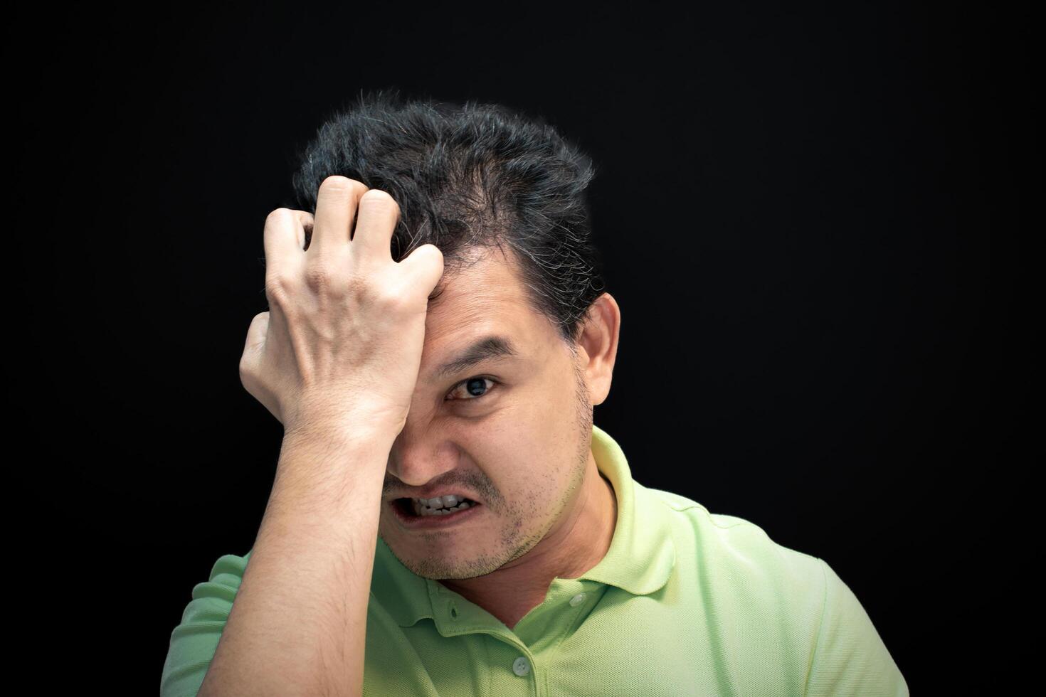 A man with his hands on his head photo