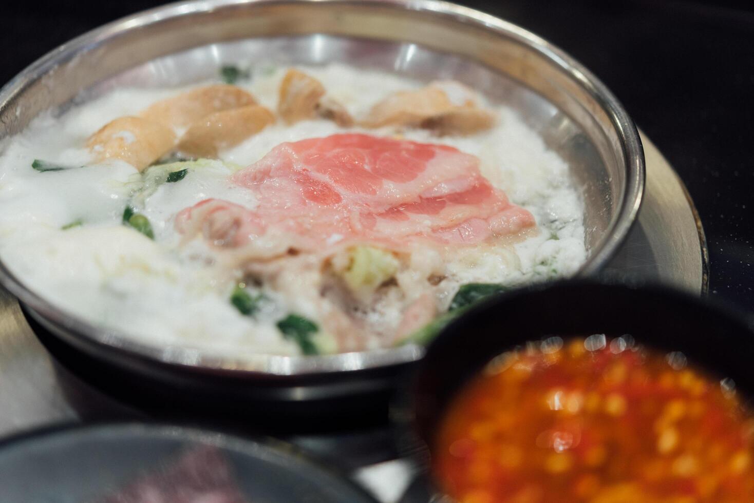 A bowl of rice with meat and vegetables in it photo