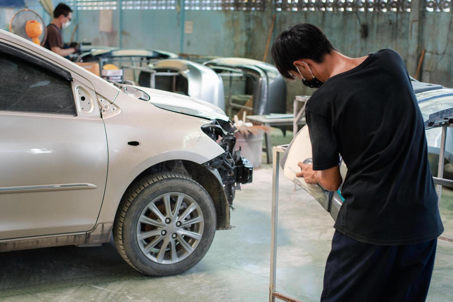 A man working on a car in a workshop photo