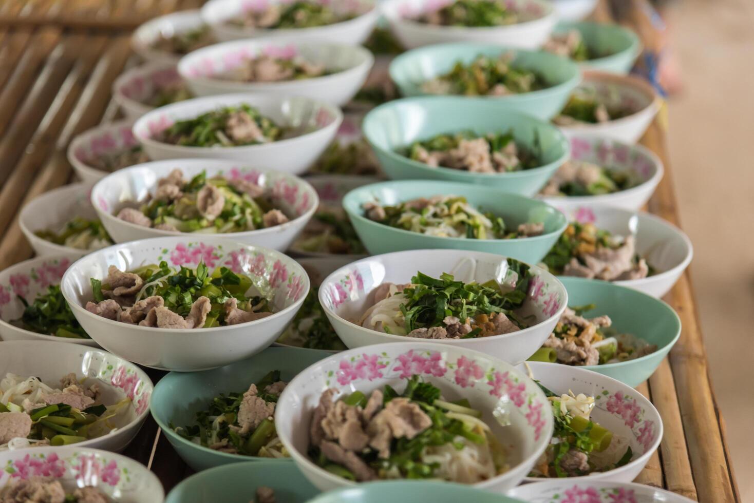 Many bowls of food are arranged on a table photo