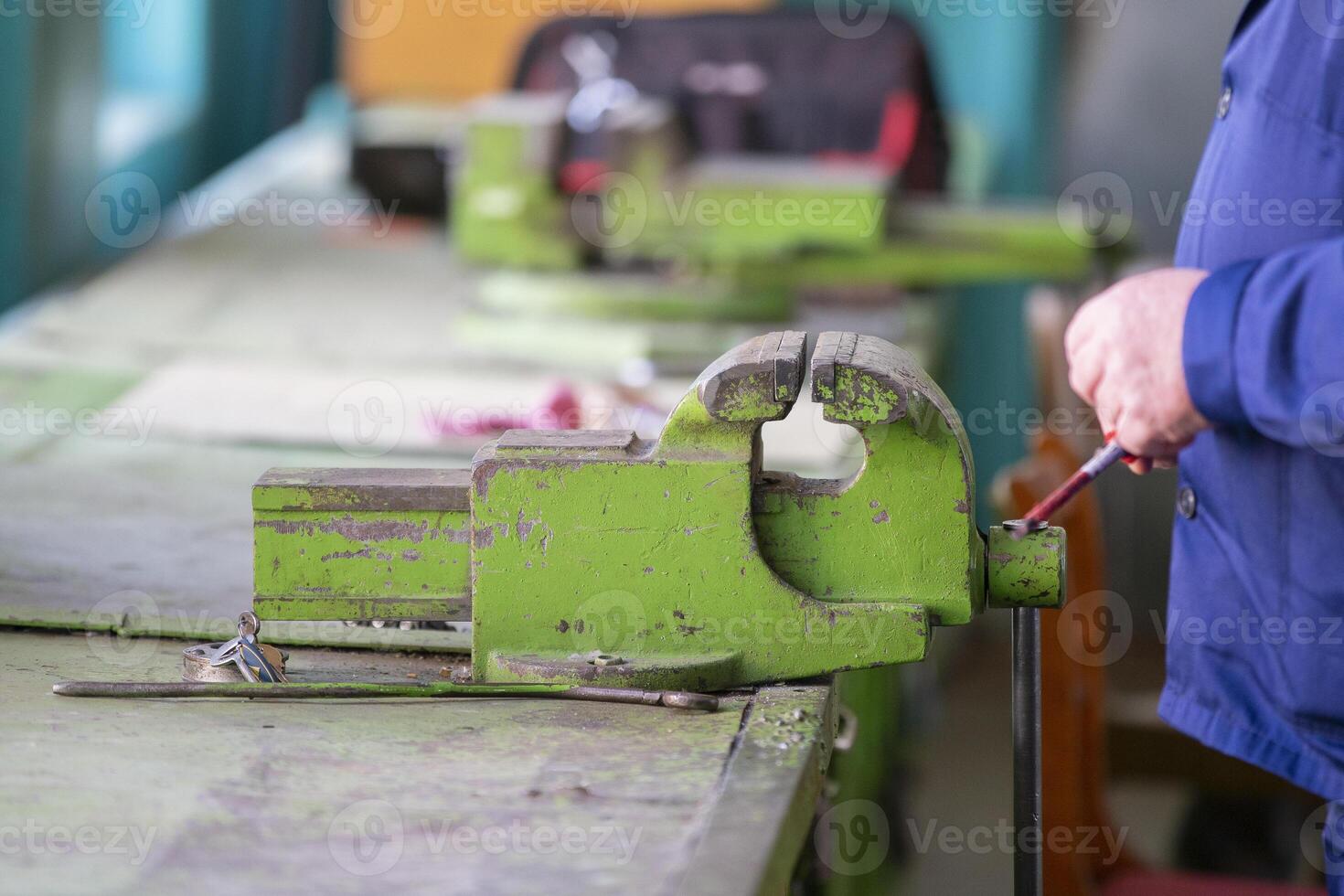 Working hands at the vise. Working locksmith photo