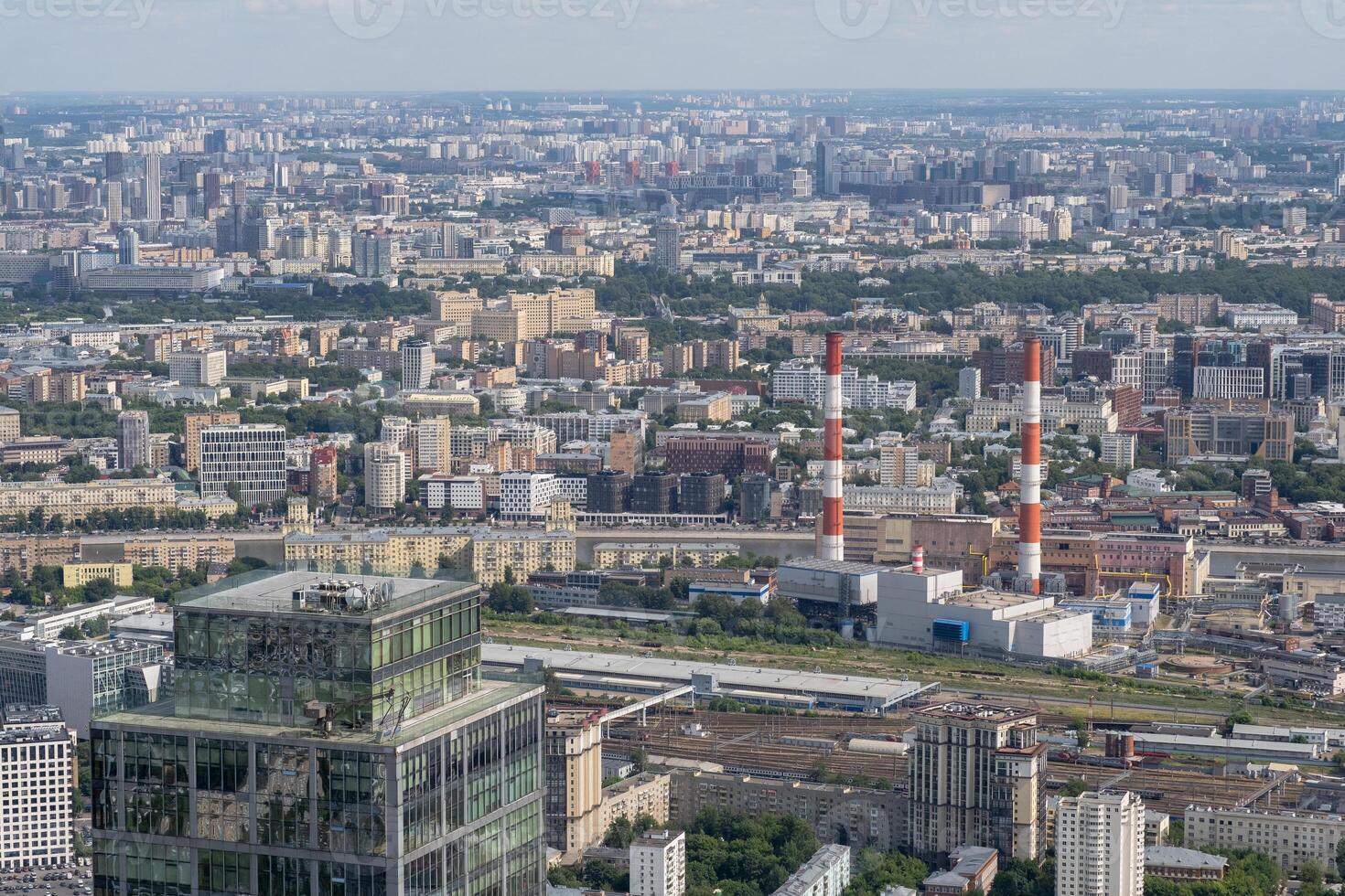 View of the Sprawling Urban Landscape of Moscow Featuring Industrial Structures and Modern Architecture on a Clear Day photo