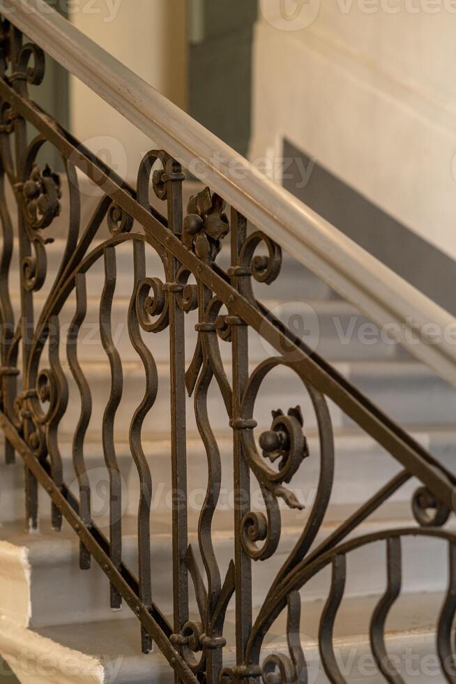 Wrought Iron Railing Design Embellishes Architectural Stairway in Elegant Building Interior photo