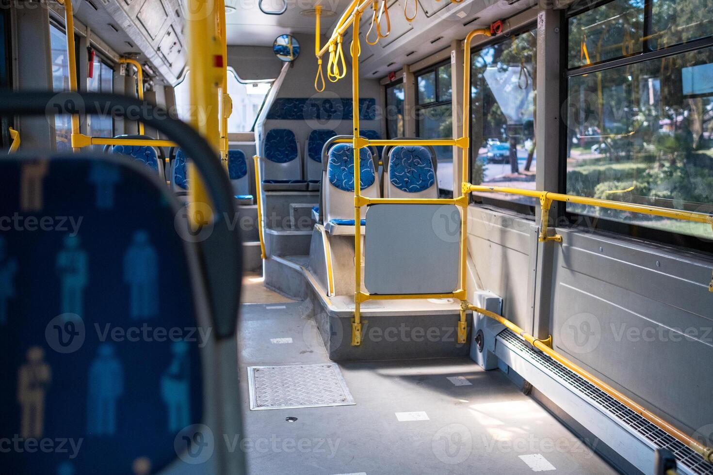 Interior of a Public Bus Showing Seating Arrangements and Accessibility Features During Daytime photo