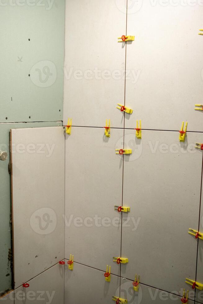 Wall Installation Process With Clips Used to Secure Panels in a Corner During a Renovation Project photo