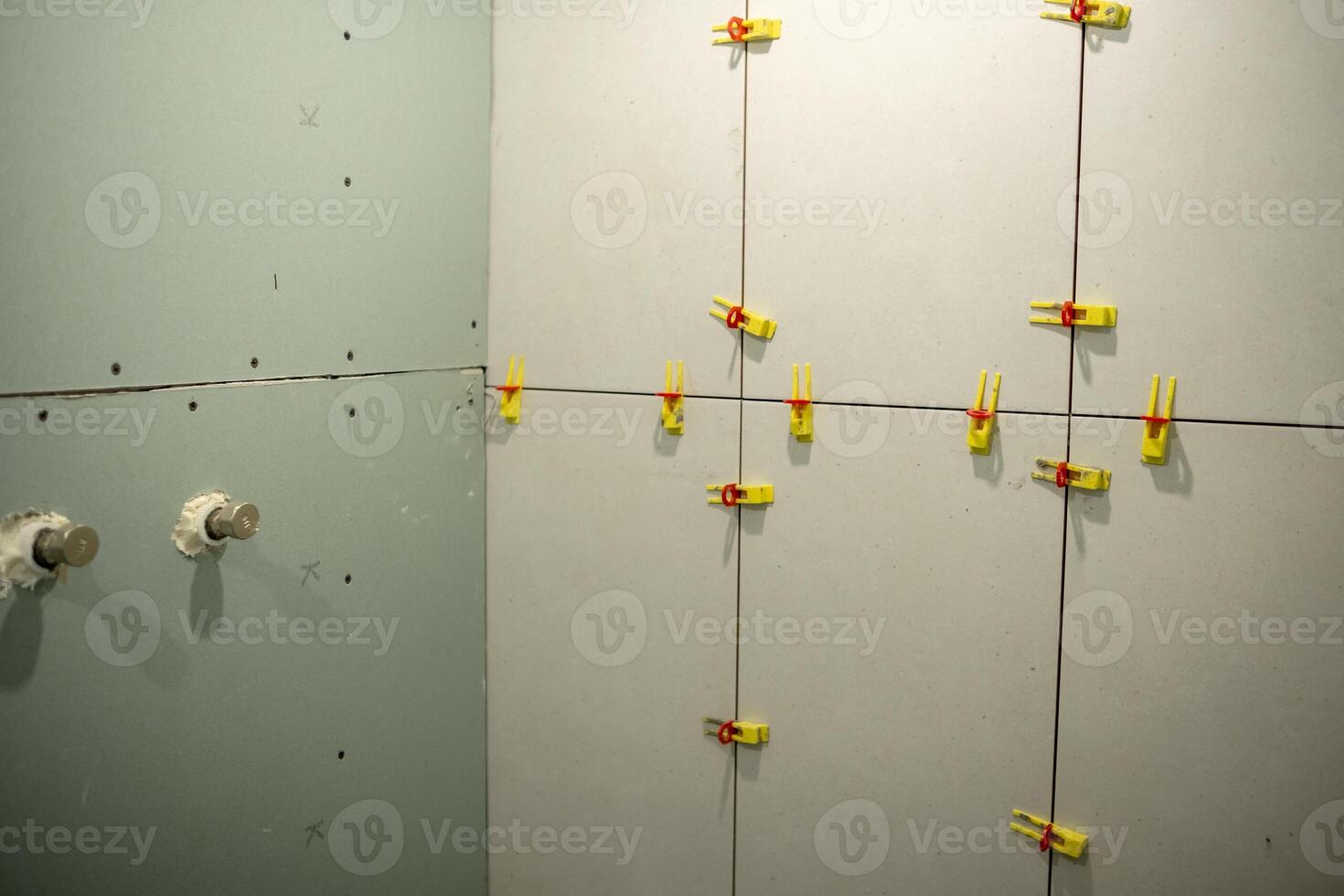 Drywall Installation in Progress With Clamps Securing Panels in a Construction Project photo
