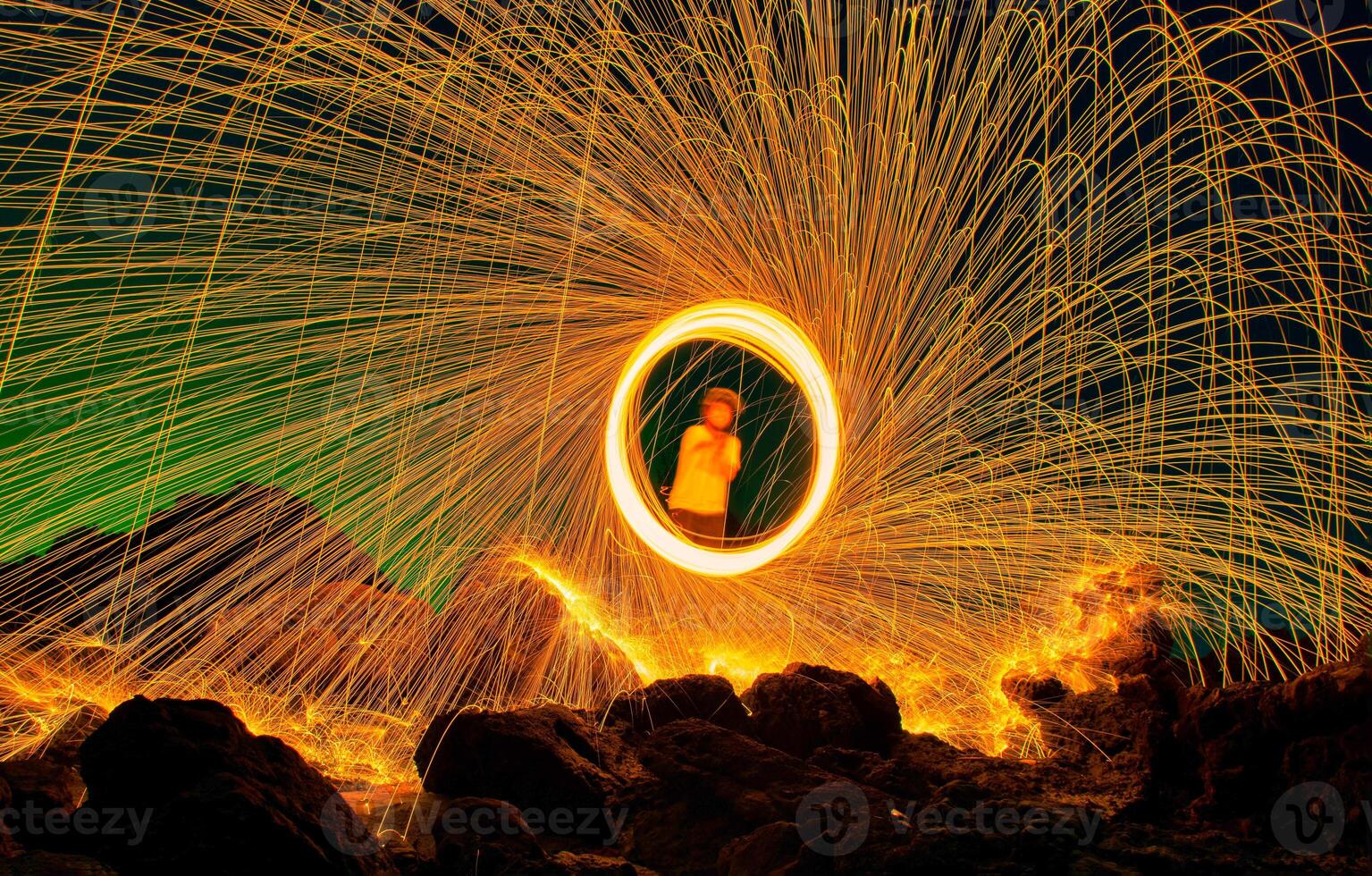 Burning steel wool on stone at night. photo