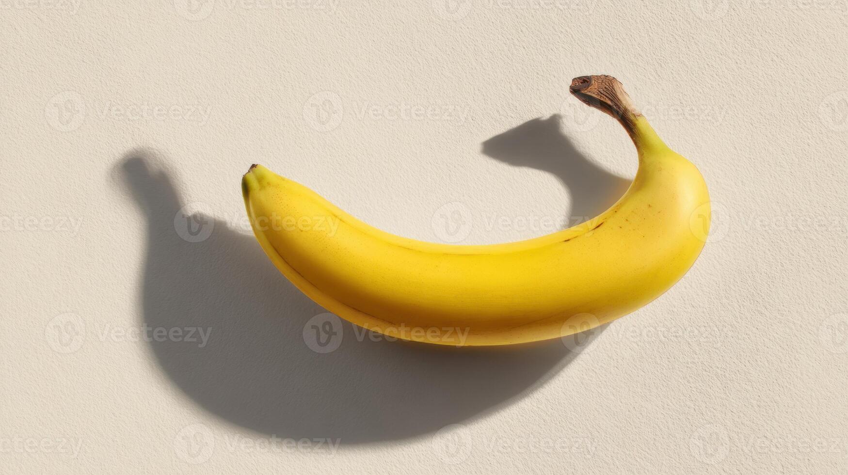 Conceptual Low Saturation Banana Casting a Shadow Against a Neutral Backdrop Creates an Artistic Visual in This Minimalistic Layout photo