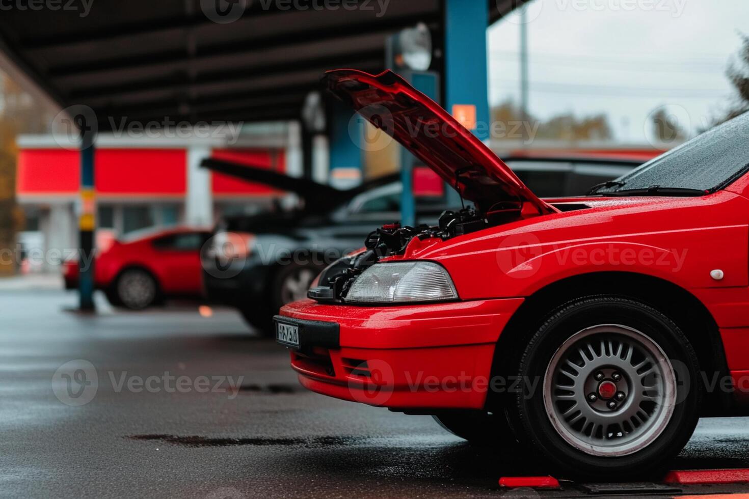 A red car with its hood open is parked in front of a red car photo