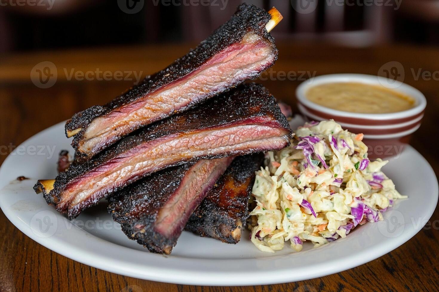 A plate with ribs and coleslaw on it photo