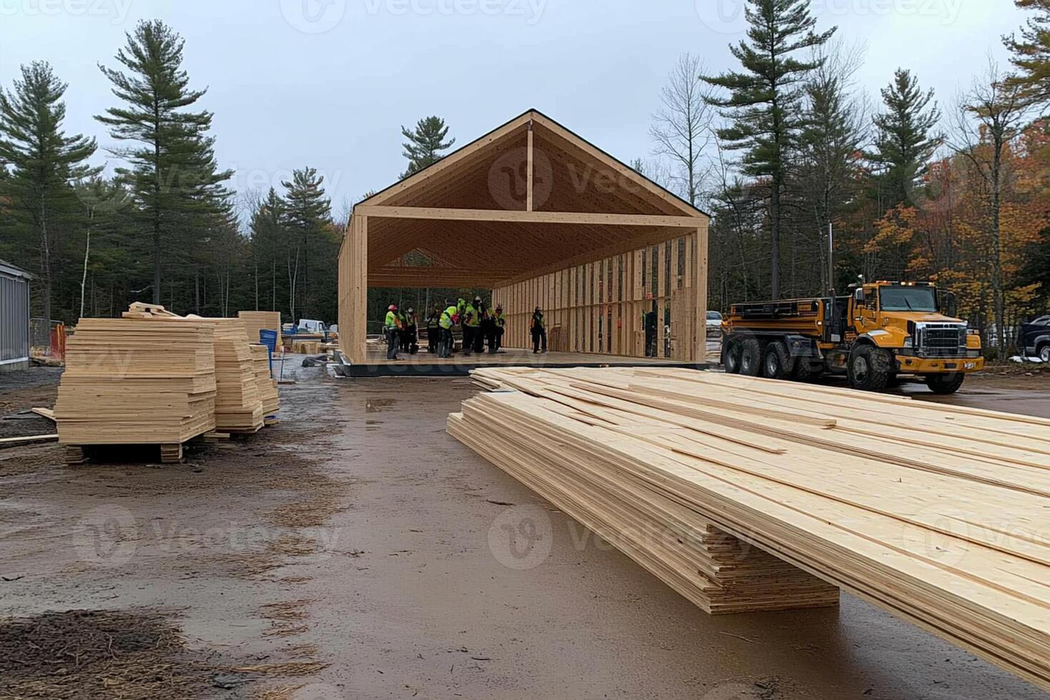 A large wooden building being constructed on a dirt road photo