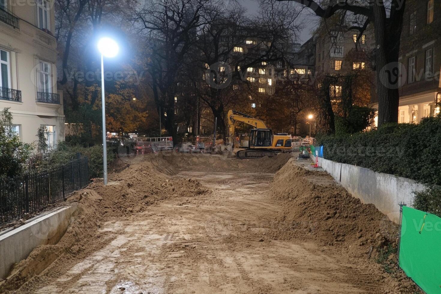 A street at night with a construction site and a light photo