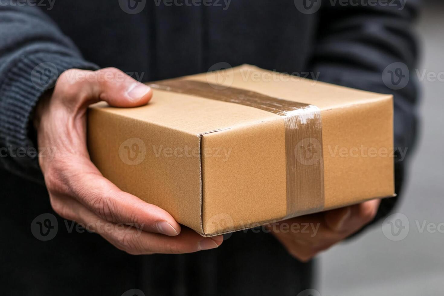 A person holding a brown box in their hand photo