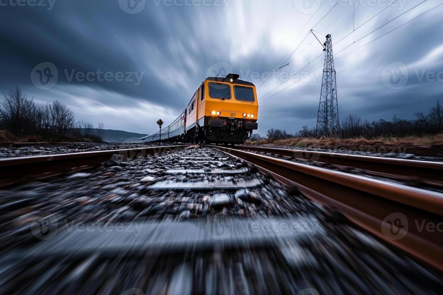 A train is traveling down the tracks on a cloudy day photo