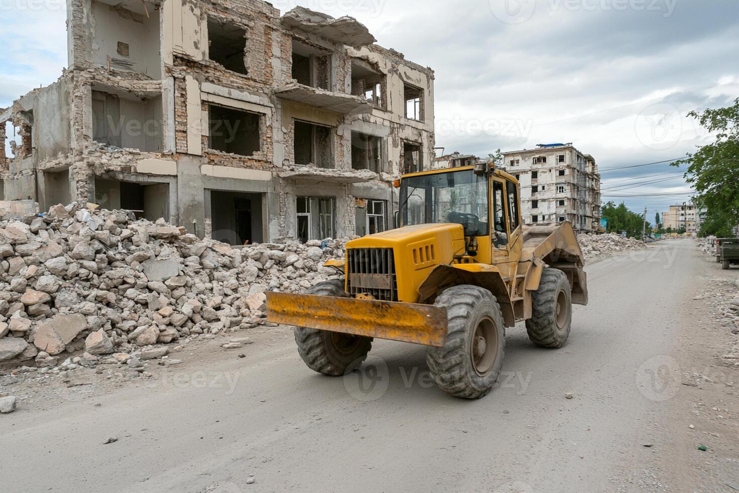 A bulldozer is driving down a road in front of a building photo