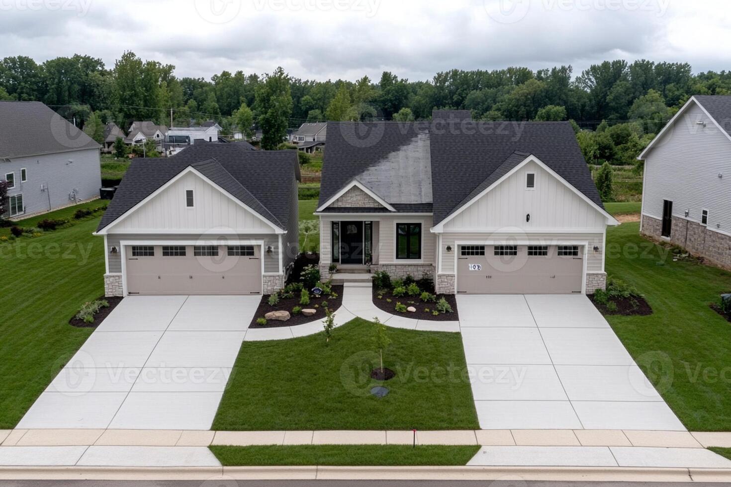 A home with two garages and a driveway photo