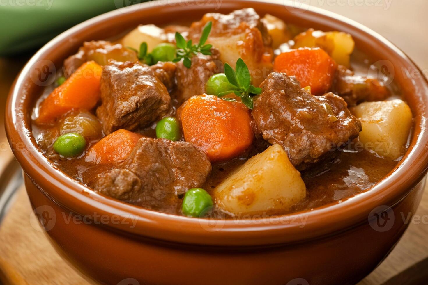 A bowl of stew with potatoes, carrots and peas photo
