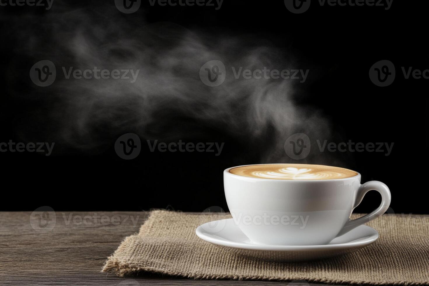 A cup of coffee with steam rising from it on a wooden table photo