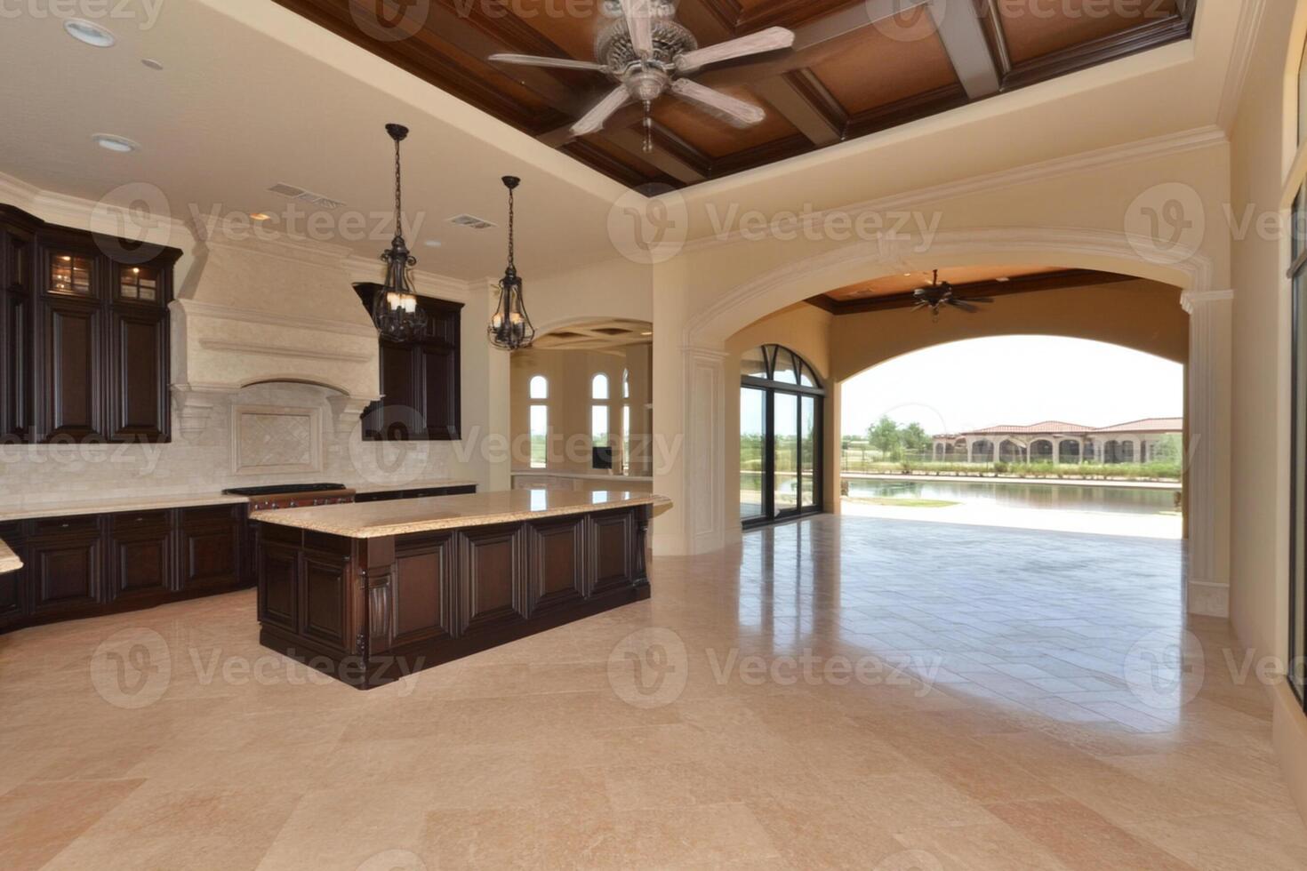 A large kitchen with a ceiling fan and a large window photo