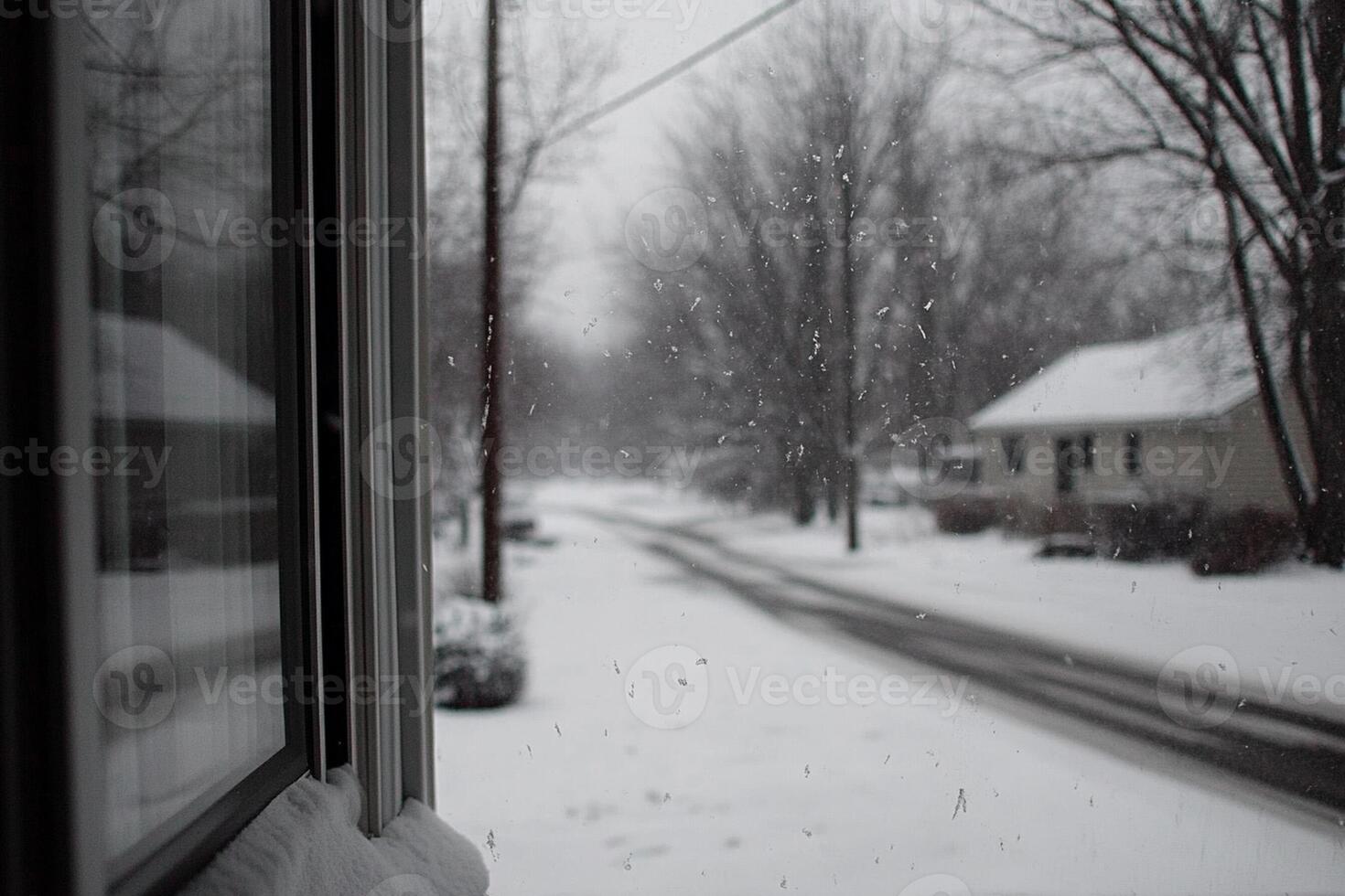 A view of a snowy street from a window photo