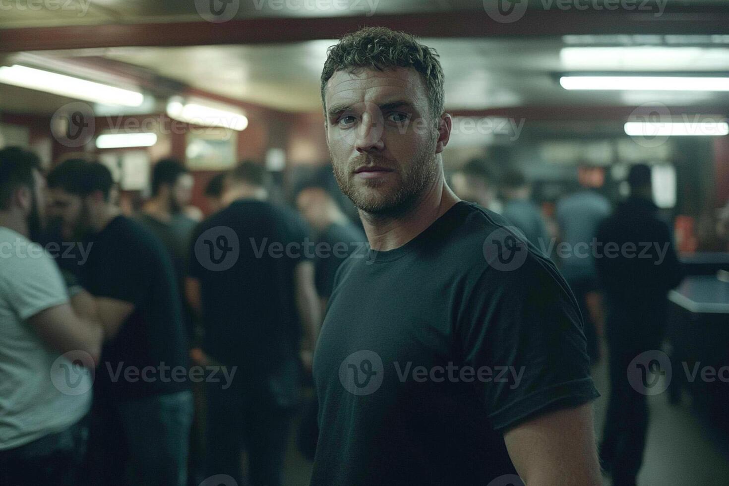 A man in a black shirt standing in a room photo