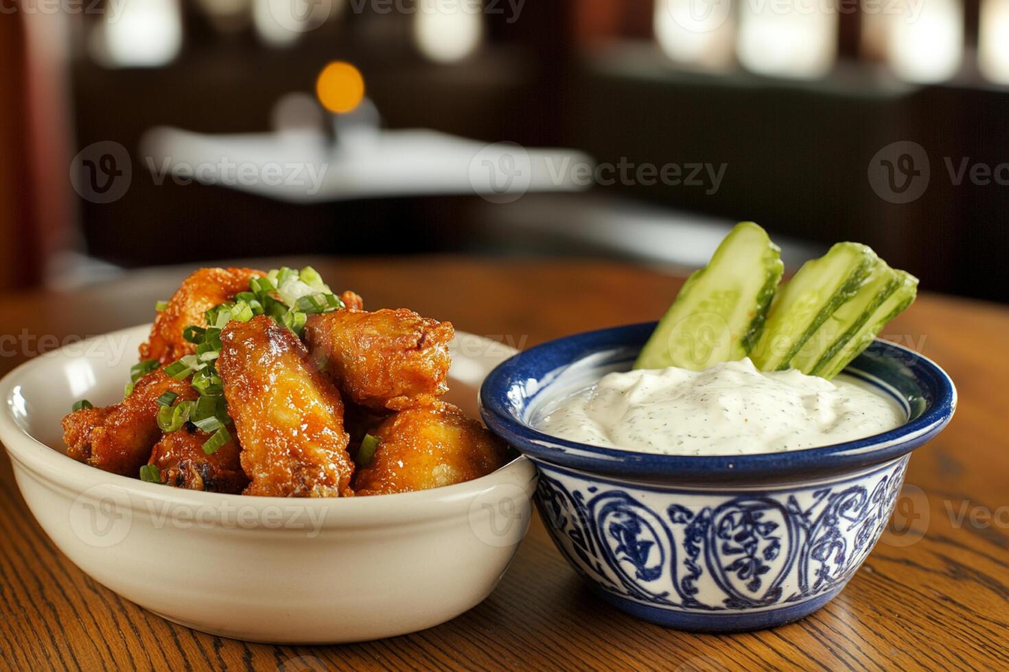 A bowl of wings and a bowl of dip photo