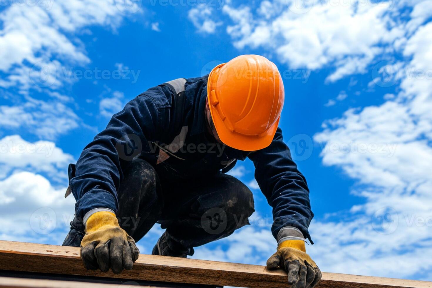A construction worker is working on a roof photo