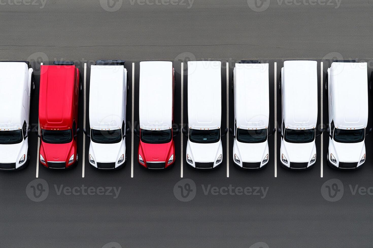 A row of white and red trucks parked in a parking lot photo