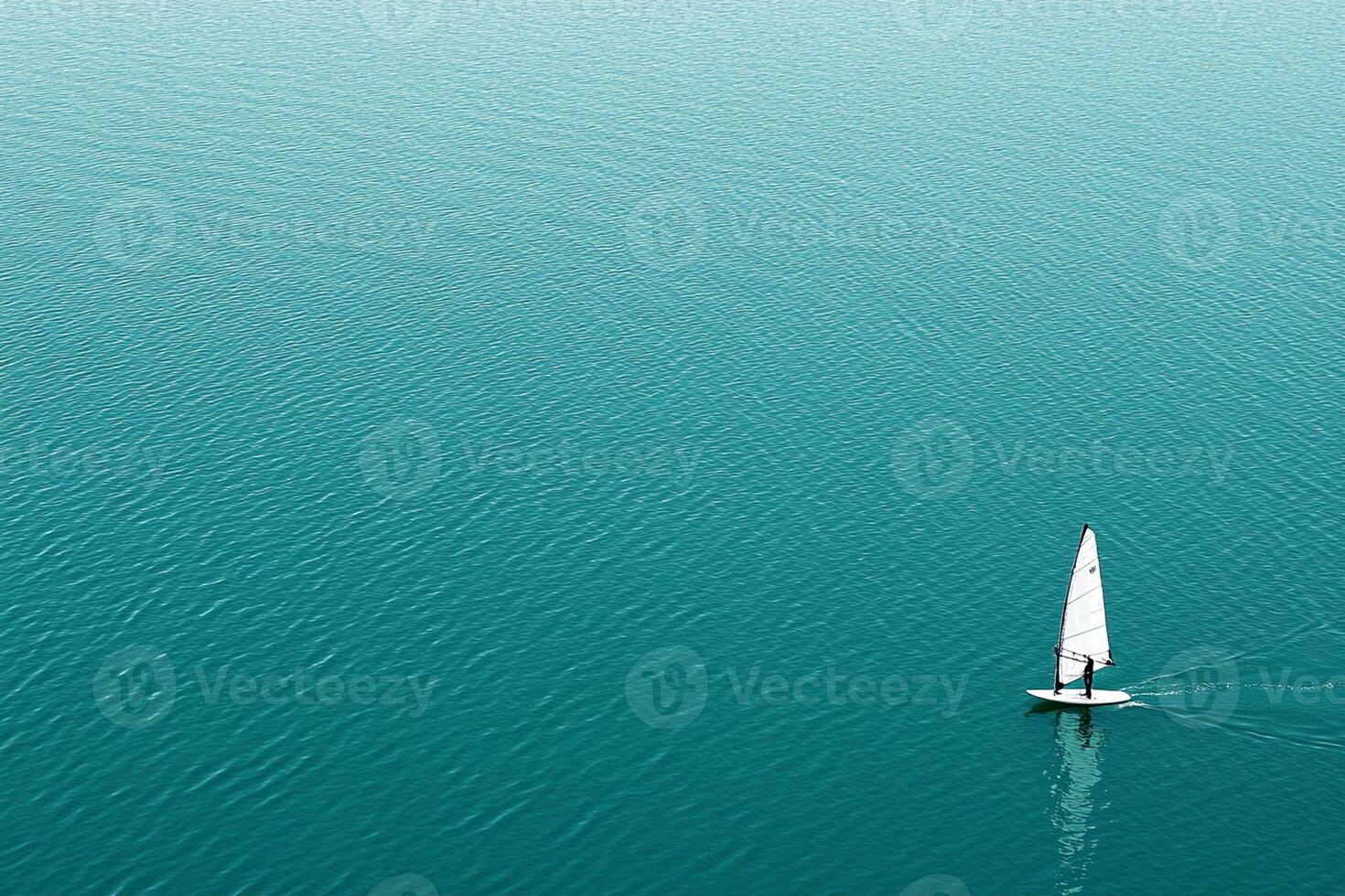 A sailboat in the middle of a large body of water photo