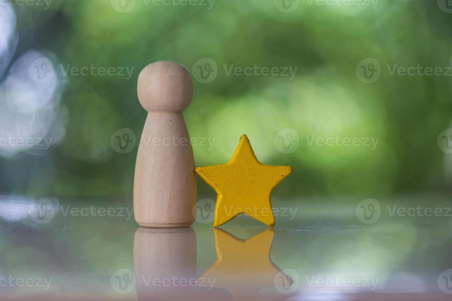Wooden peg doll standing together with yellow star. The concept of a candidate. photo