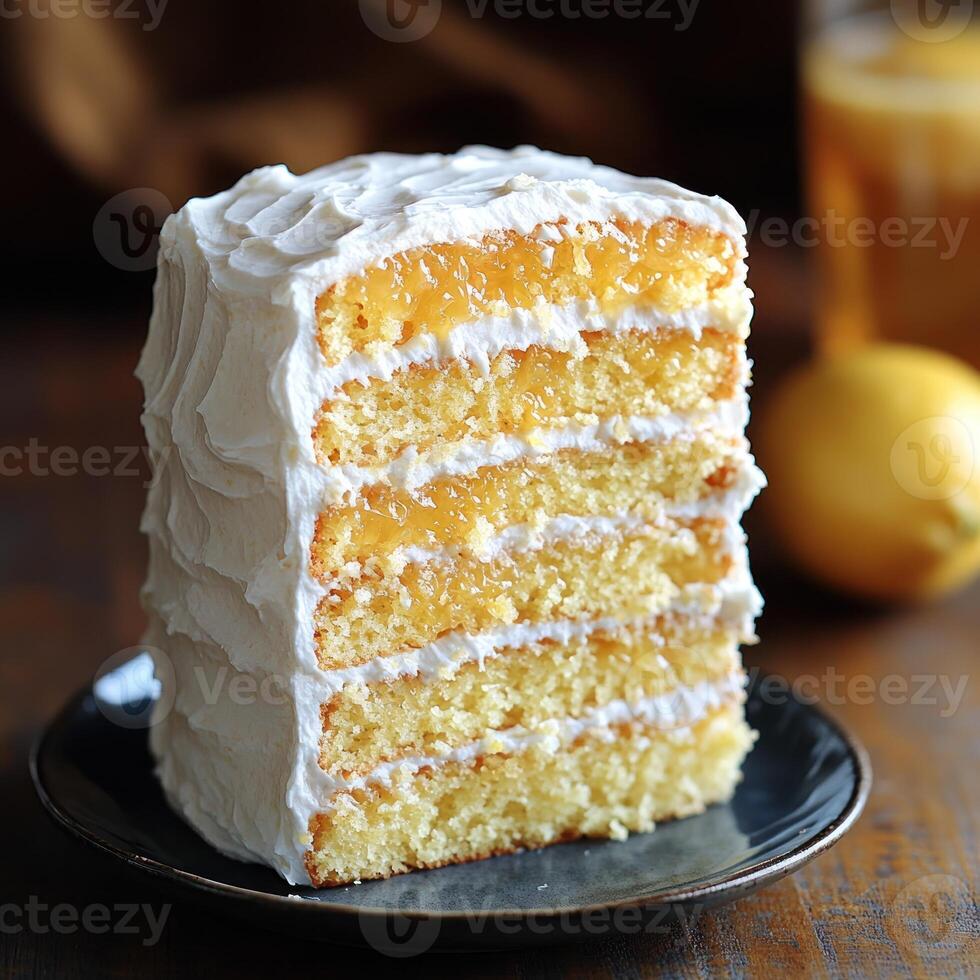 Delightful lemon layer cake served on a rustic plate with refreshing drink nearby photo