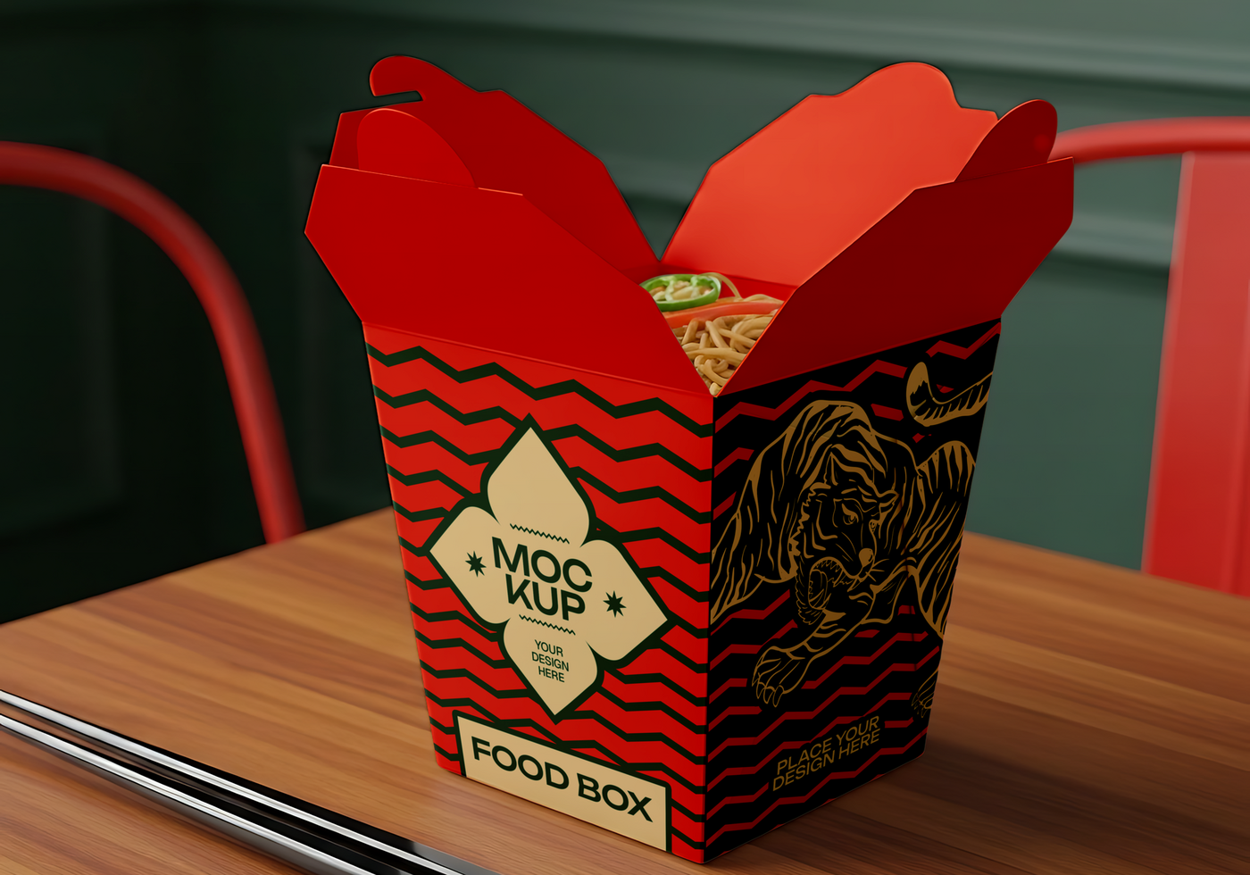 A red and black food box with a tiger design holds a serving of noodles psd