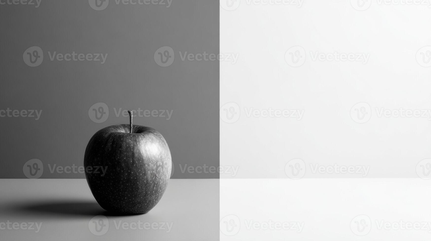 Single Colored Apple Stands out in a Grayscale Minimalist Layout With an Empty Right Side photo