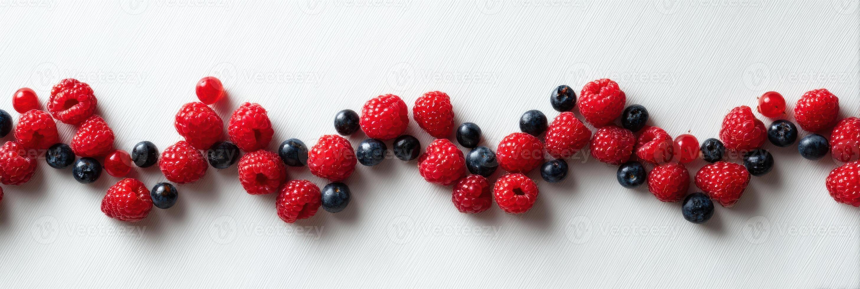 Berries Arranged in a Symmetrical Wave Shape on a Clean White Background Creating a Vibrant and Fresh Appearance photo