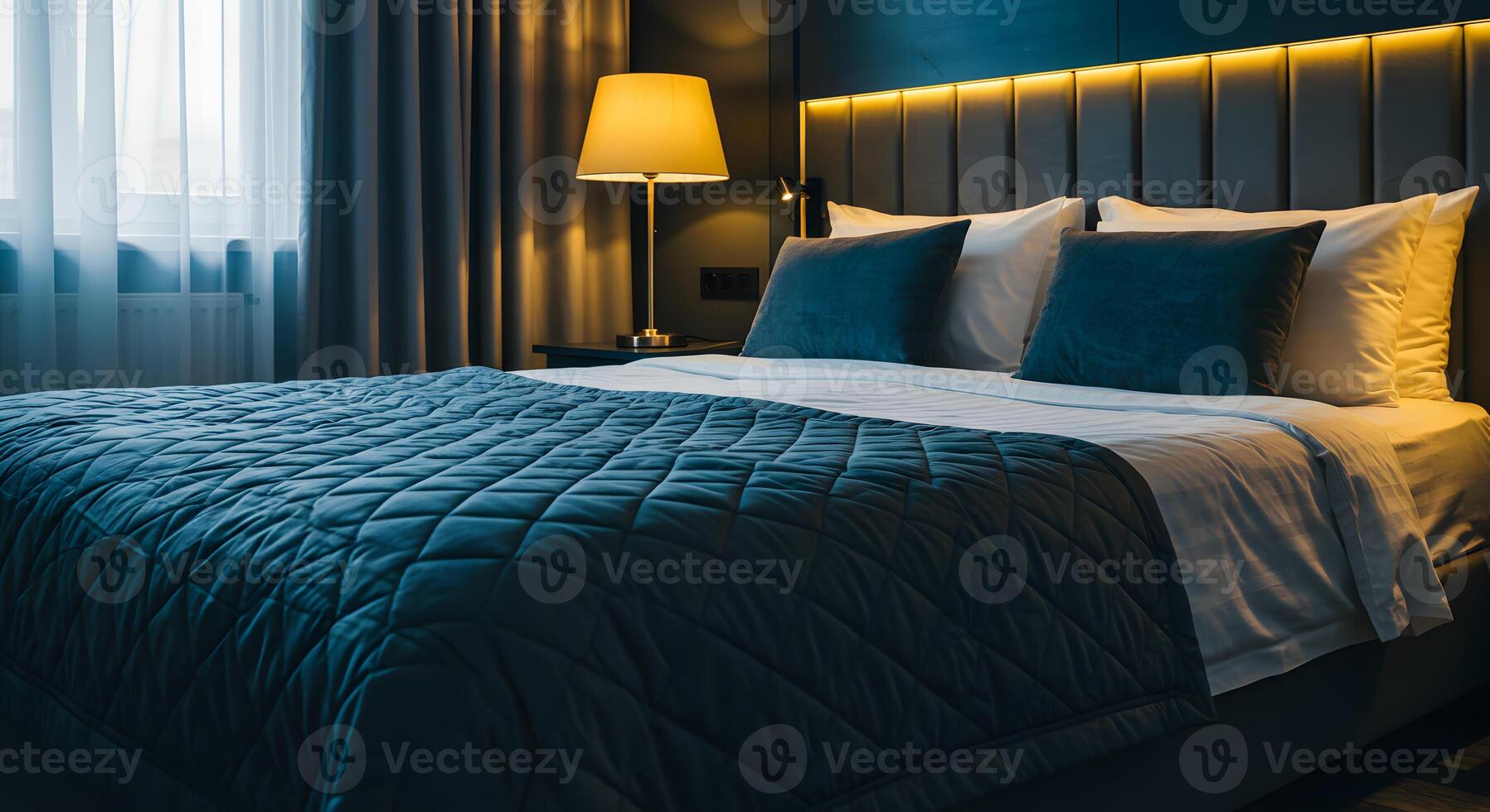 Luxurious hotel bedroom with a comfortable bed plush pillows and warm ambient lighting photo