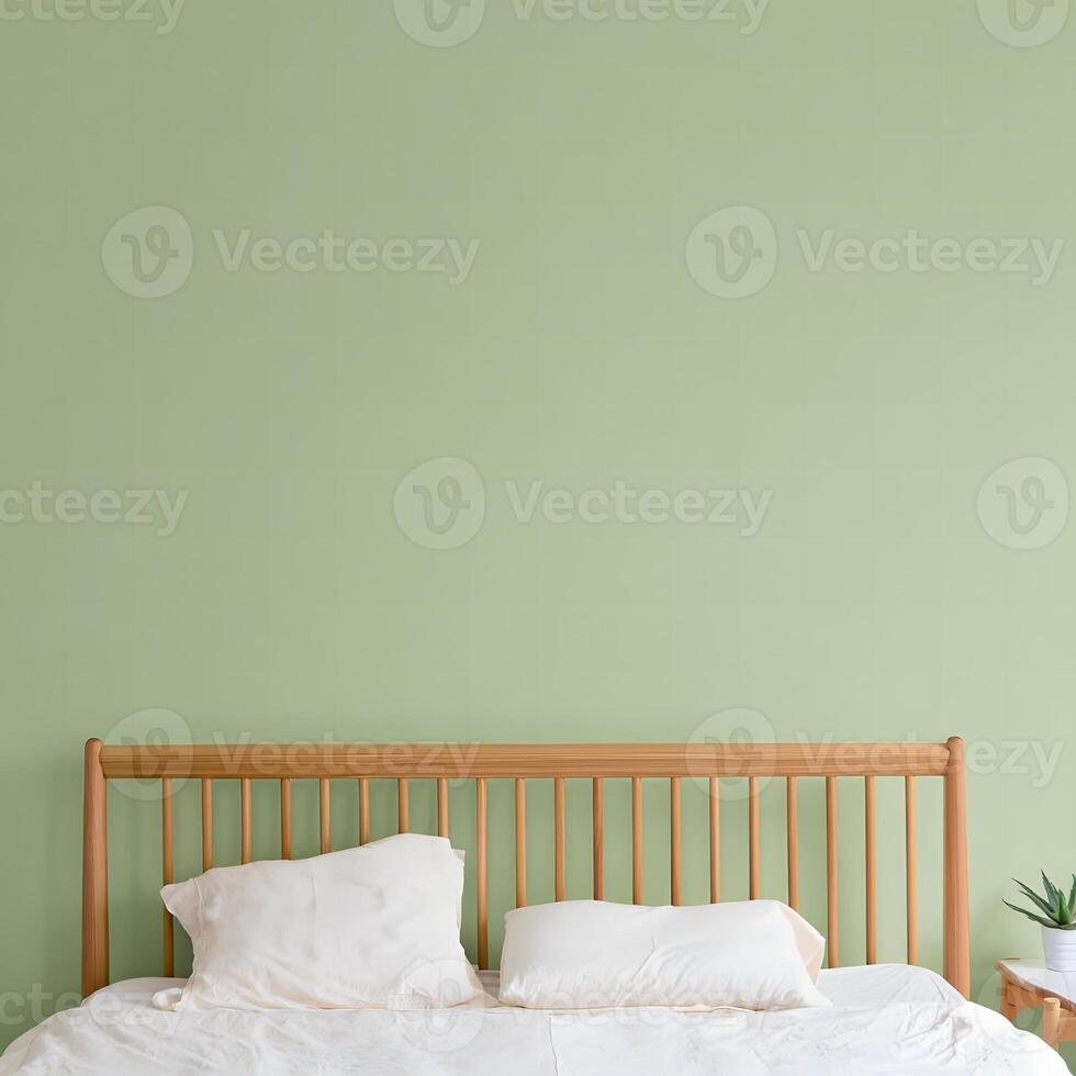 Cozy bedroom with a wooden headboard and soft pillows against a light green wall photo