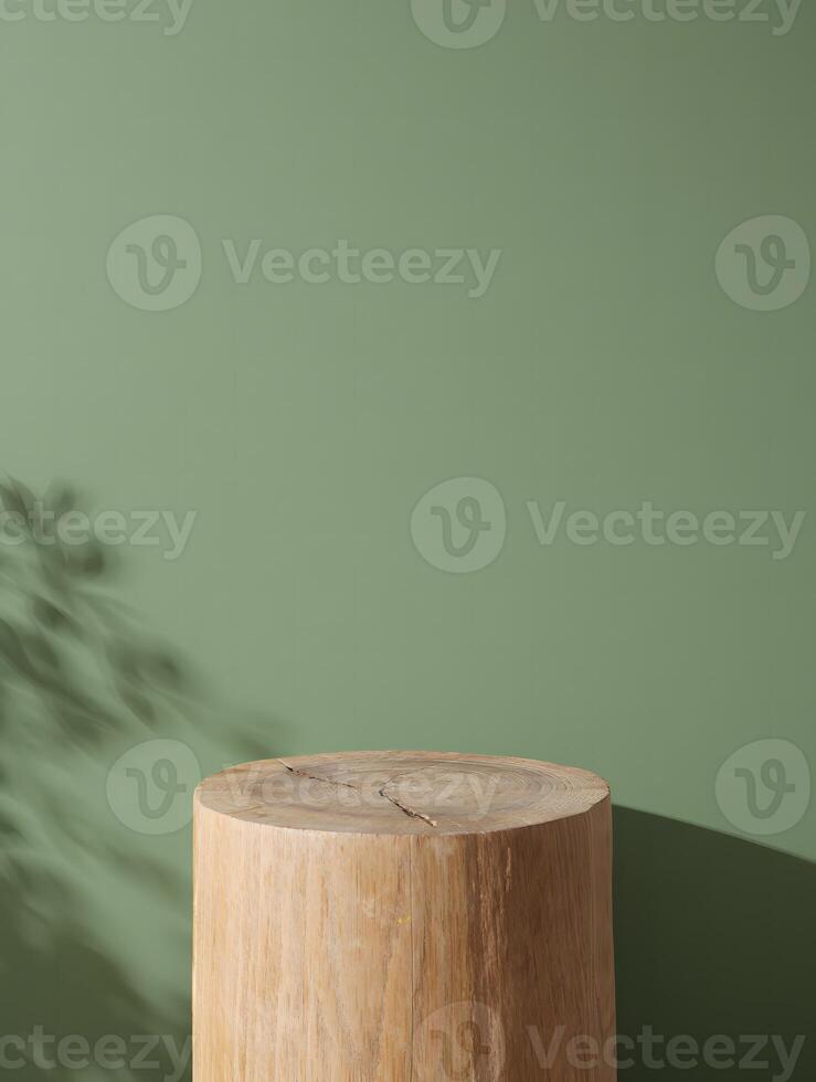 Natural wooden log podium with soft leaf shadows on a muted green background photo