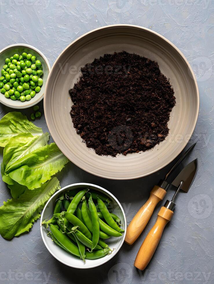 Fresh garden vegetables including peas and lettuce with soil and gardening tools photo