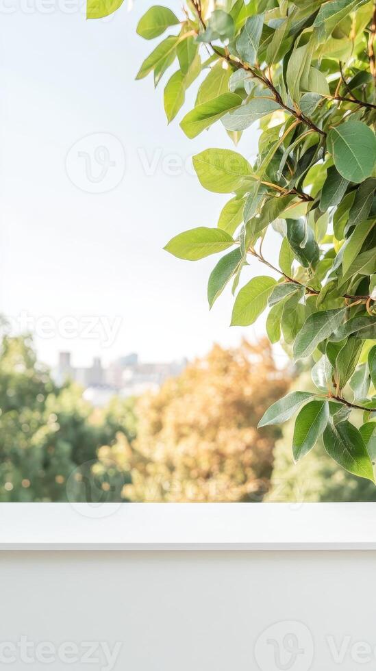 Vibrant green leaves frame a serene outdoor view with soft natural light, overlooking a tranquil blurred city skyline from a peaceful vantage point. photo