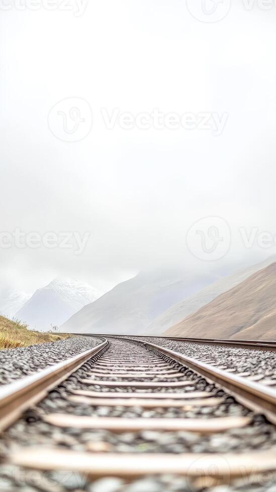 Misty Mountain Railway Journey Serene Train Tracks Winding Through a Vast, Cloud-Kissed Landscape, Inviting Contemplation of Distant Horizons photo