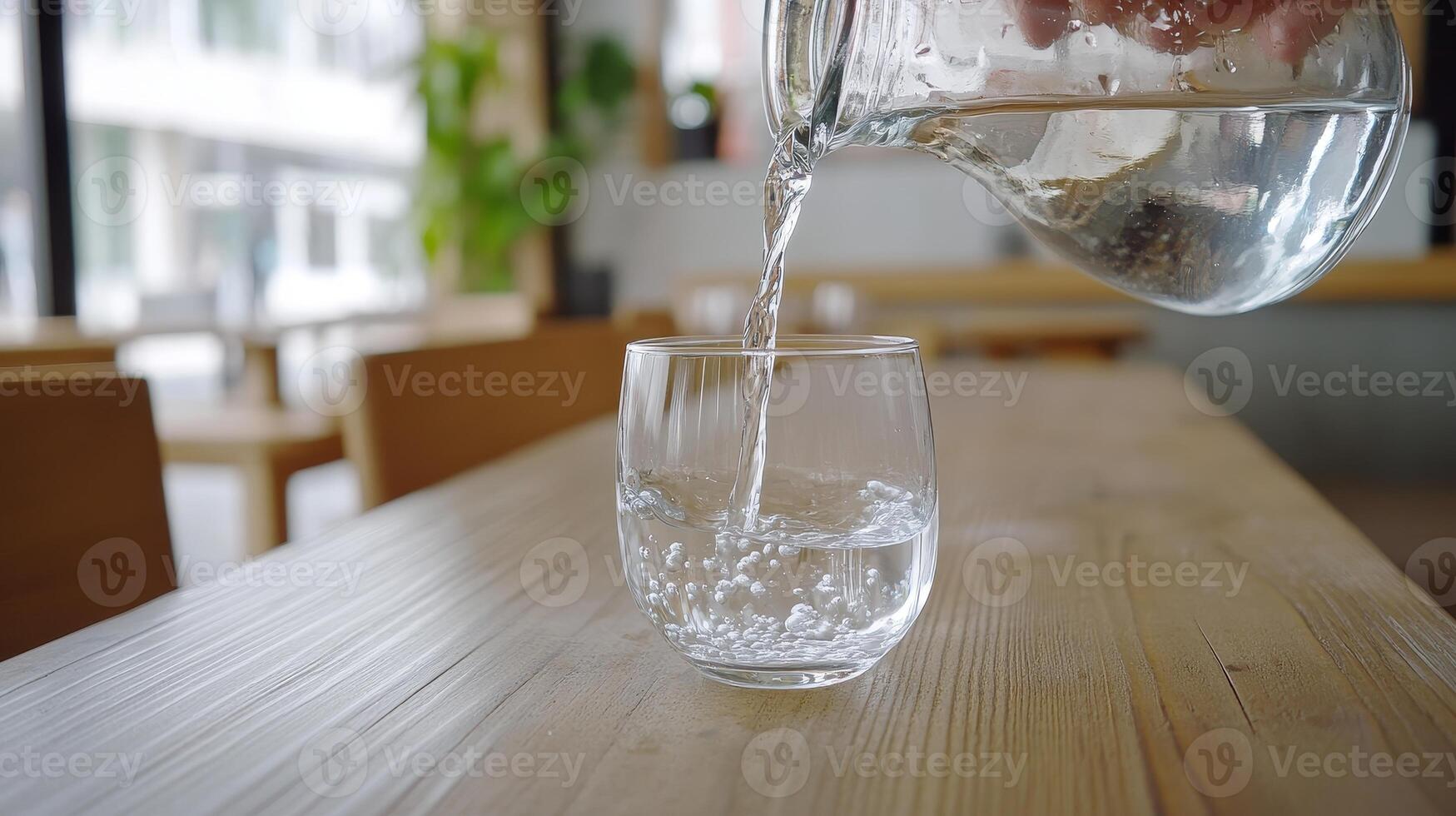 Crystal Clear Water Pouring into a Glass on a Wooden Table A Refreshing Moment of Purity and Hydration Indoors photo